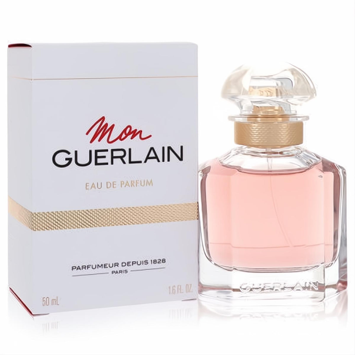 Luxurious Mon Guerlain Eau De Parfum 1.6 oz spray in an elegant clear glass bottle with pink fragrance, gold neck, and iconic quadrilobe stopper, beside its white branded box.