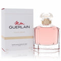 Mon Guerlain 3.3 oz women's Eau De Parfum. Elegant clear glass bottle with delicate pink fragrance, gold neck, and white box.