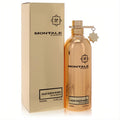 Montale Aoud Queen Roses 3.4 oz unisex Eau de Parfum. Glimmering metallic gold bottle with signature star charm, next to its elegant box.