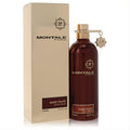 Elegant Montale Boise Fruite 3.4 oz unisex EDP. Luxurious metallic burgundy bottle with a gold cap and charm, alongside its sleek gold box.