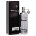 Luxurious Montale Vanilla Cake 3.4 oz unisex EDP. Sleek silver metallic bottle with charm, displayed beside its elegant black box.