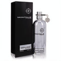 Sleek Montale Wood & Spices 3.4 oz Eau de Parfum. Iconic silver metallic bottle with charm next to its elegant black box.