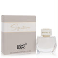 Montblanc Signature 1.7 oz EDP for women. Modern white faceted bottle with gold Montblanc cap, beside its elegant grey and gold box.