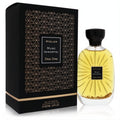 Luxurious Atelier Des Ors Musc Immortel 3.3 oz EDP spray. Clear bottle with shimmering gold flakes, next to its elegant black art deco box.