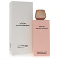 Experience Narciso Rodriguez All of Me 6.7 oz scented body lotion. Chic pink bottle, rose gold cap, and elegant white box.