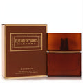 Elegant Elizabeth and James Nirvana Bourbon 1 oz EDP spray in a rich amber textured glass bottle, beside its luxurious brown and gold box.