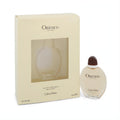 Calvin Klein Obsession 0.5 oz EDT spray. Elegant oval glass bottle with dark cap, displayed next to its cream box with clear window.