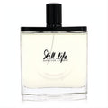 Olfactive Studio Still Life unisex EDP. Clear glass bottle with pale amber liquid, sleek black cap, and elegant black script.