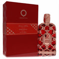 Orientica Amber Rouge 5 oz unisex Eau de Parfum spray in a luxurious red bottle with intricate rose gold filigree design and matching box.