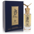 Oud Al Saqr 3.4 oz unisex EDP spray. Clear bottle with majestic gold eagle crown cap, beside a sophisticated navy box.