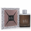 Luxurious Oud Najdia by Lattafa 3.4 oz unisex EDP. Distinctive textured brown bottle, silver cap, and elegant patterned box.