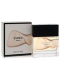 Chic Peau De Soie Starck Paris unisex EDT spray. Clear glass bottle with black cap, light beige liquid, and elegant white box.