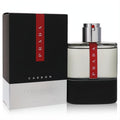 Sleek Prada Luna Rossa Carbon 3.4 oz men's cologne. Clear glass and matte black bottle with a bold red stripe, beside its matching box.
