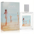 Pure Grace Summer Moments 2oz EDT: clear glass spray bottle & light blue box with serene beach art. Embrace summer's fresh scent.