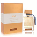 Luxurious Rasasi Qasamat Rasana 2.2 oz unisex EDP. Clear bottle with intricate gold pattern, brown cap, blue tassels, and matching gold box.