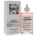 Maison Margiela Replica Flower Market 3.4 oz EDT. Captivating pink fragrance in a sleek clear bottle with silver cap and white floral box.