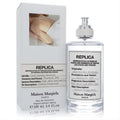 Maison Margiela Replica Lazy Sunday Morning 3.4 oz EDT. Clear glass bottle, silver cap, white label, and matching box.