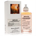 Maison Margiela Replica On A Date 3.4 oz EDT. Luxurious amber unisex fragrance in a clear bottle with a fabric label and white box.