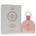 Captivating Rihanah Secret Musk 3.4 oz EDP. Frosted pink bottle, elegant shell cap, rose gold accents, and matching white box.