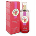 Vibrant Roger & Gallet Gingembre Rouge 3.3 oz wellbeing water spray in a sleek clear bottle with gold accents, beside its elegant red and pink box.