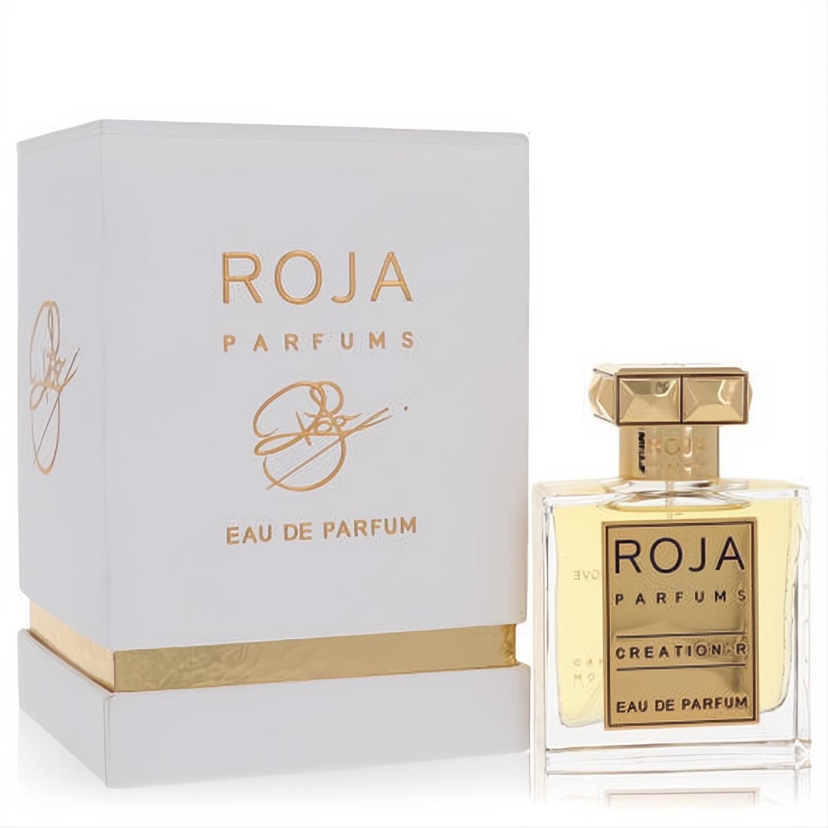 Luxurious Roja Creation-R Eau De Parfum. Clear glass bottle with ornate gold cap and label, next to its elegant white and gold box.