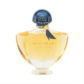 Captivating Guerlain Shalimar Eau de Toilette 3 oz. Golden liquid in a sculpted glass bottle with a deep blue cap and ribbon.