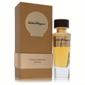 Salvatore Ferragamo Vendemmia 3.3 oz unisex EDP spray. Elegant clear glass bottle with golden fragrance, beside its luxurious golden-brown box.