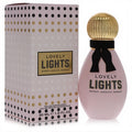 Lovely Lights SJP 1 oz EDP features a blush pink bottle, elegant gold ribbed cap, black ribbon bow, and a playful polka dot box.