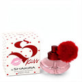 Shakira S Kiss 1.7 oz Eau de Toilette: a playful pink glass bottle with a vibrant red pom-pom, beside its iconic polka dot box.