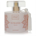 Chic Simone Cosac Sublime women's perfume bottle, light pink with intricate rose gold floral patterns and a pearl-accented white tassel.