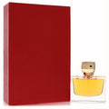 Jovoy Sombres Dessins 1.7oz perfume: golden liquid in a clear bottle with a chic gold cap, beside its vibrant red box.