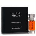 Luxurious Swiss Arabian Amaani concentrated perfume oil in an amber bottle with an ornate silver cap, beside its sleek black box.