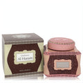 Exquisite pink and brown Swiss Arabian Dukhoon Al Haram bakhoor container, richly decorated with gold patterns, beside its elegant display box.