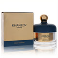 Elegant Swiss Arabian Dukhoon Khaneen fragrance jar with a striking gold knob and dark blue lid, next to its matching gold and blue box.