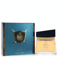 Luxurious Swiss Arabian Ghazi Oud fragrance. Amber liquid in a sleek glass bottle, beside its bold teal box with a shield and swords.
