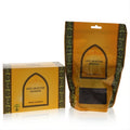 Luxurious Swiss Arabian Oud Muattar Mumtaz incense. Golden box and pouch with elegant Arabian design, showing dark oud inside.