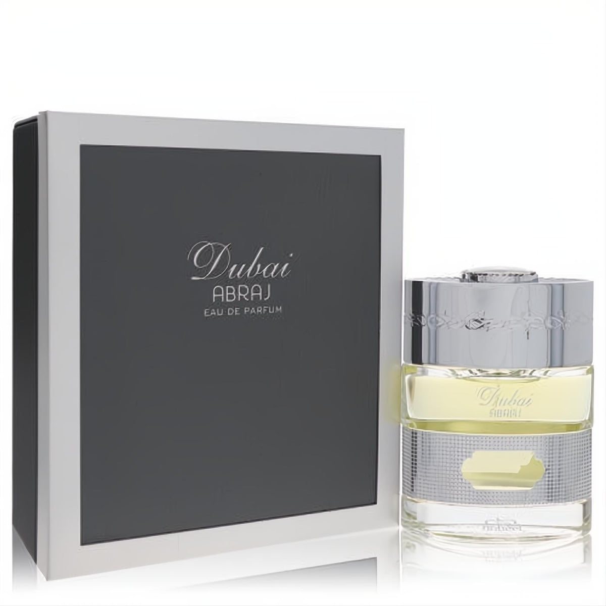 The Spirit of Dubai Abraj 1.7 oz Eau De Parfum. Elegant bottle with pale yellow fragrance, ornate silver cap, and luxurious dark grey box.