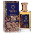 Luxurious The Woods Collection Twilight unisex Eau de Parfum, 3.4 oz. Clear bottle with amber liquid, rose gold cap, and a dark blue botanical box.