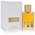 Luxurious Tom Ford Costa Azzurra 3.4 oz EDP spray. Golden fragrance in a ribbed glass bottle with gold cap, beside its elegant white box.