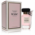 Victoria's Secret Tease 3.4 oz EDP: elegant pink bottle, black faceted cap, delicate sheer bow, and chic pink/gold box.