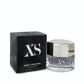 Paco Rabanne XS 1.7 oz EDT spray: sleek clear bottle with faceted silver cap, next to its iconic matte black box.